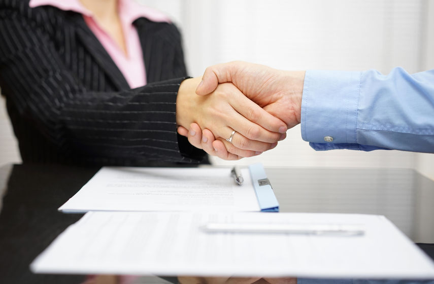 business partner and client  are handshaking over signed contrac